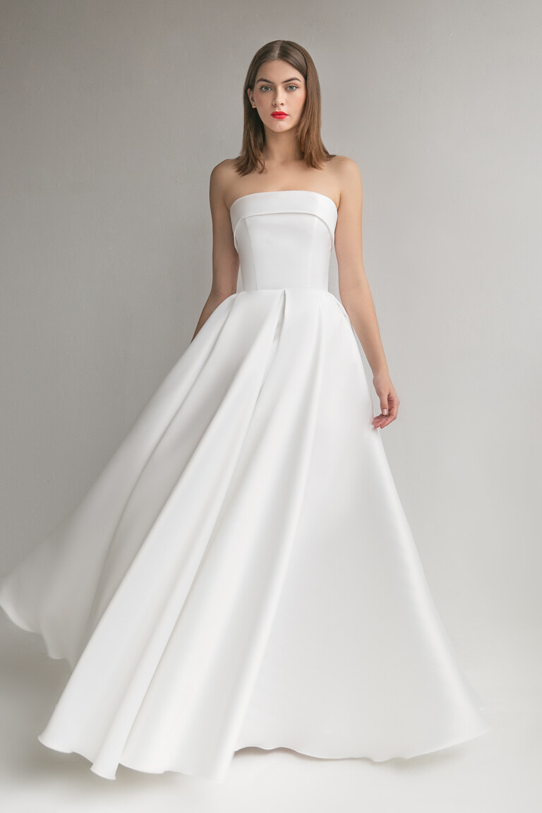 Sophie modern ivory wedding dress front view with strapless neckline and floor length pleated skirt