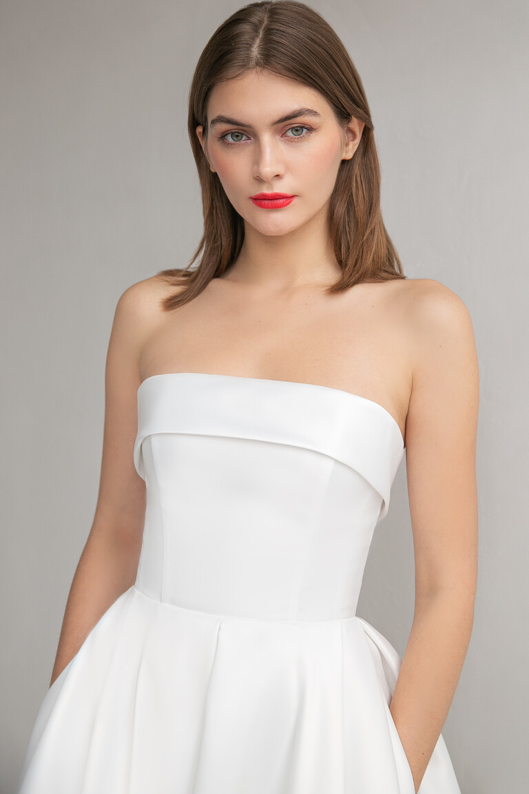 Sophie dress bodice detail showing strapless straight neckline with modern folded flap design