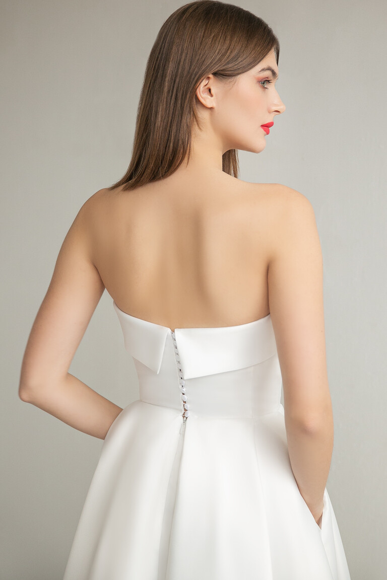 Elegant Open Back with Fabric Covered Buttons Rear view detail of Sophie Midi dress showing open back with buttons and folded cuff bodice in ivory