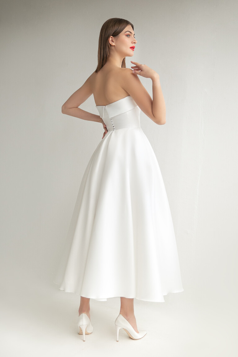 Sophie Midi Dress Angled Back View Three-quarter back view of Sophie Midi ivory gown highlighting A-line silhouette and buttoned back
