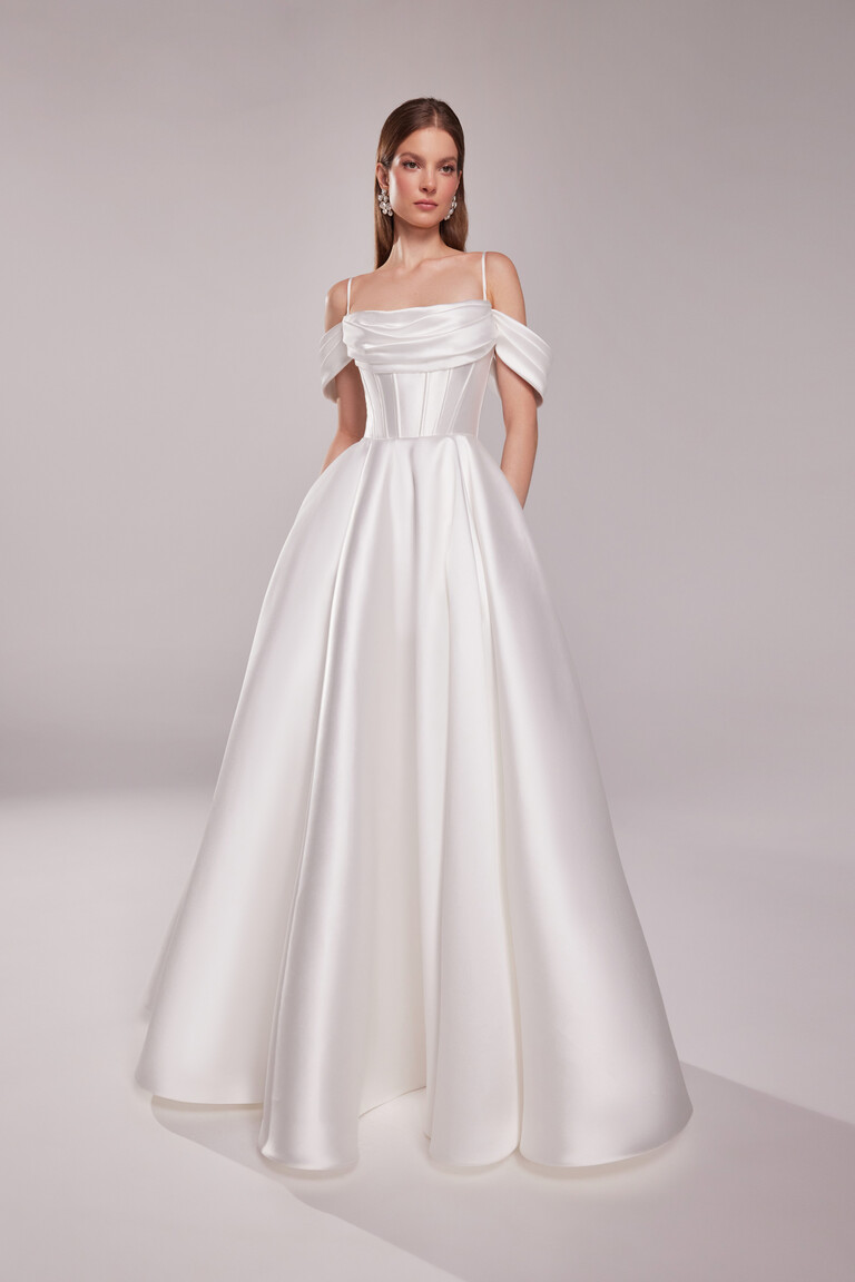 Full length Sunny bridal gown in ivory mikado showing pleated A-line skirt and draped cowl neckline