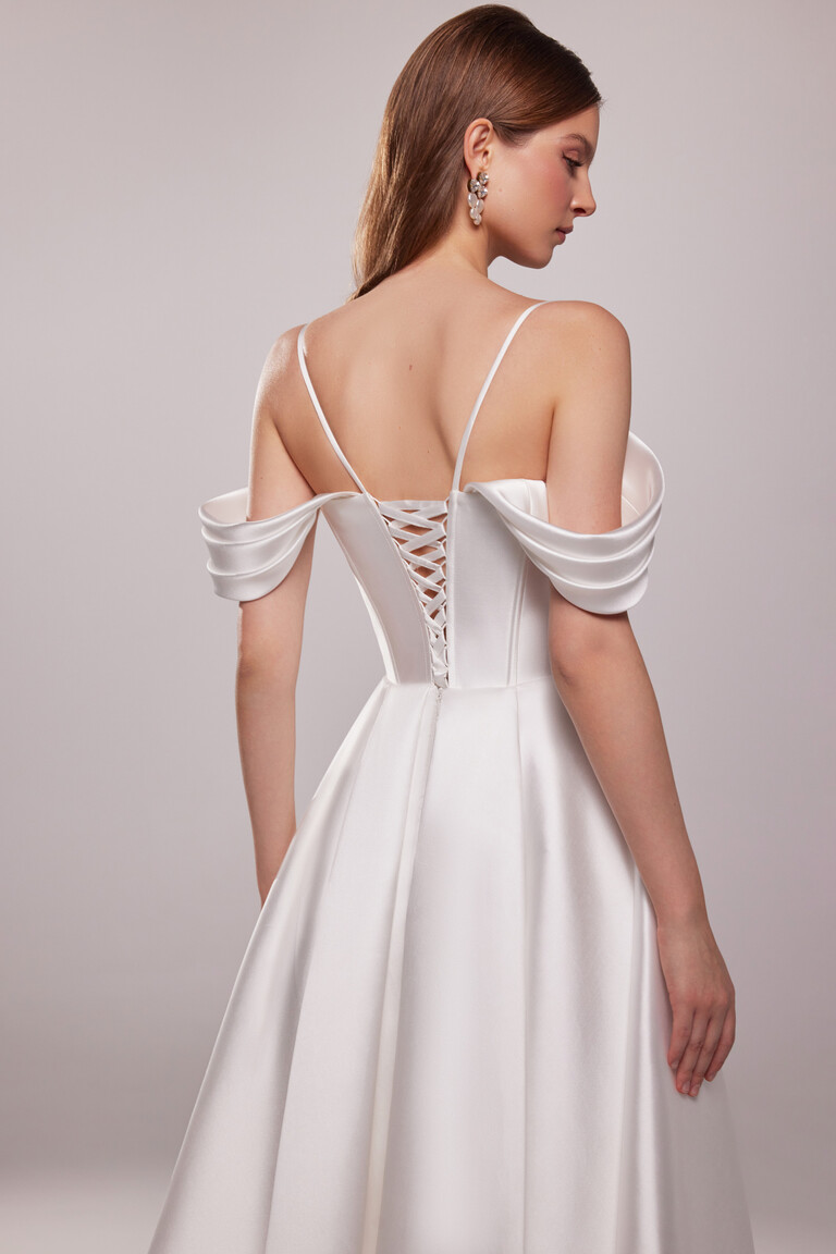 Back view of Sunny mikado gown featuring lace-up closure and off-the-shoulder draped sleeves