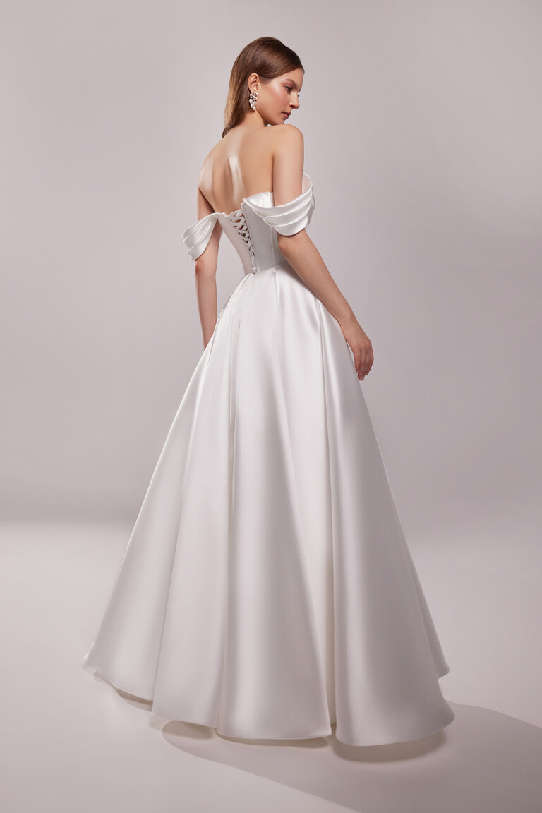 Sunny A-line bridal gown rear angle showing voluminous mikado skirt and lace-up back fit