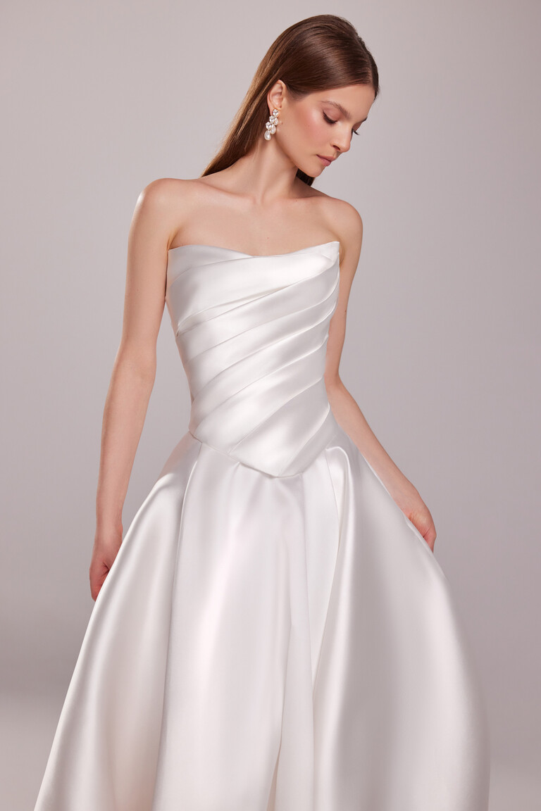 Detail of Tori gown showing diagonal draping on strapless corset bodice and basque waistline