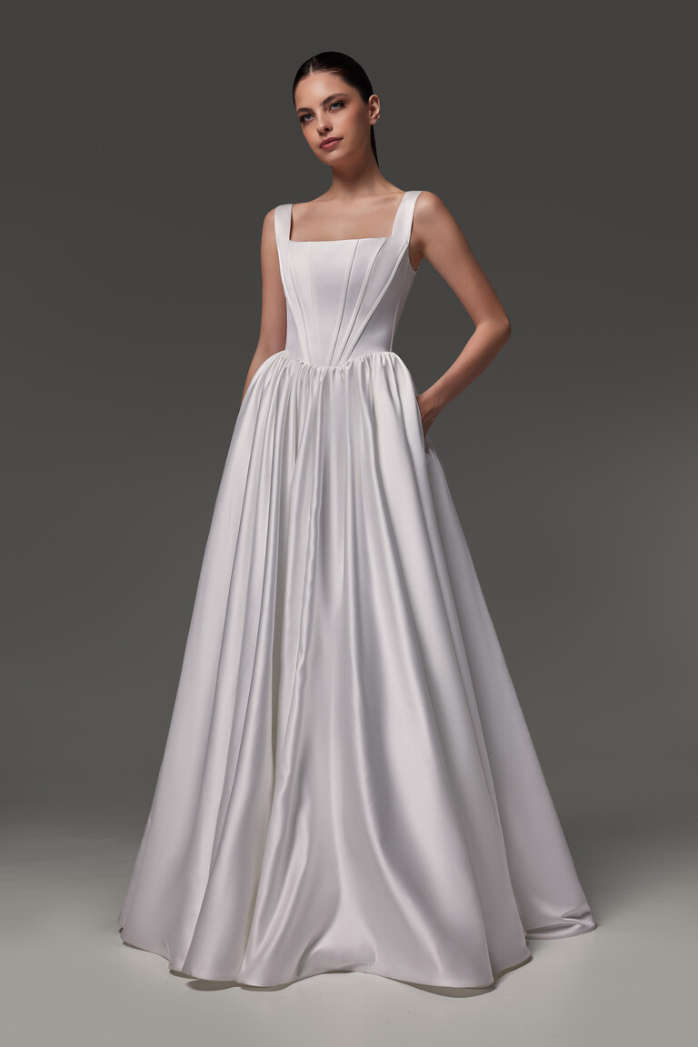 Casia A-line wedding gown featuring functional side pockets and structured basque waist