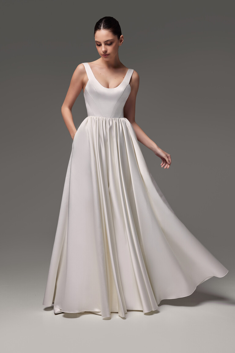 Unona Barbara ivory A-line wedding dress shown from the front highlighting the smooth satin fabric and full voluminous skirt.