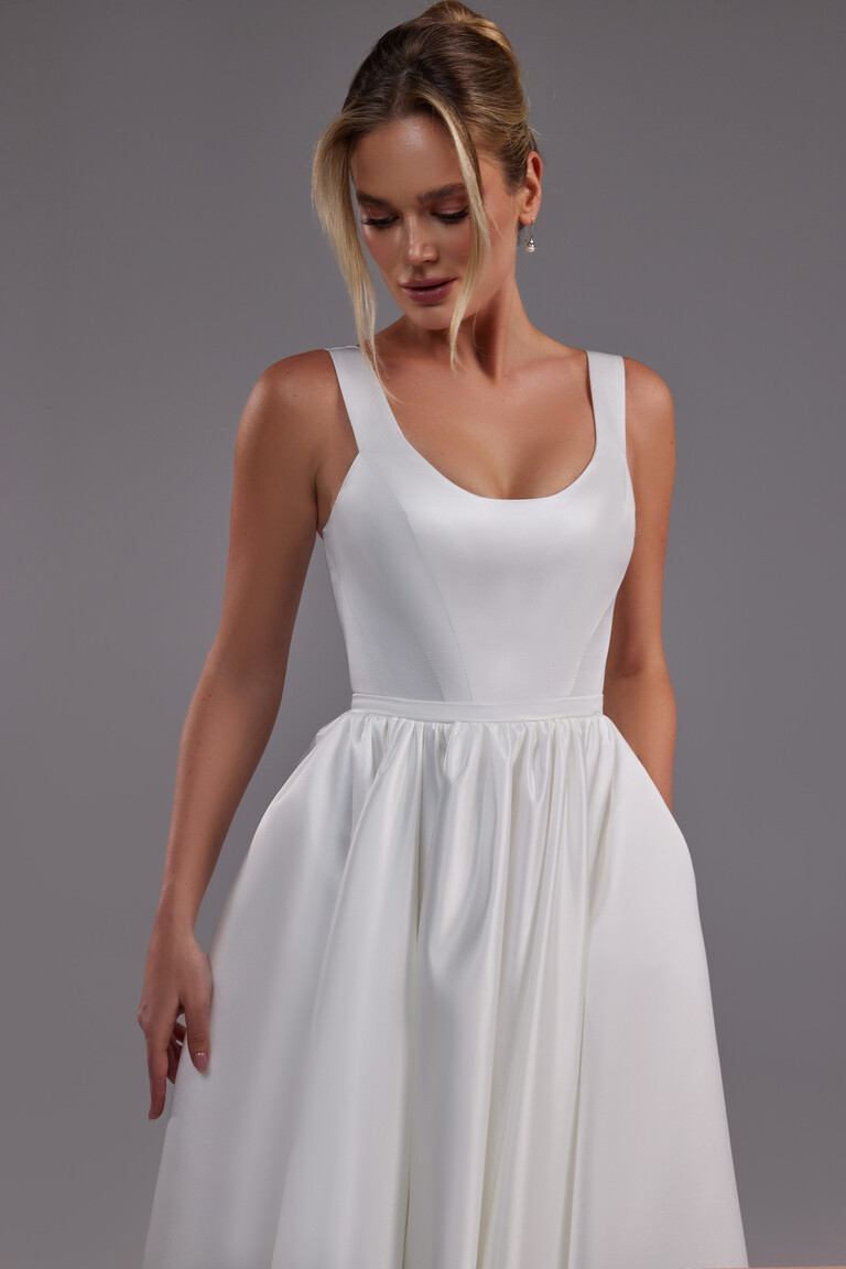Three-quarter front view of the Unona Barbara satin A-line dress showcasing its minimalist design and convenient side pockets.
