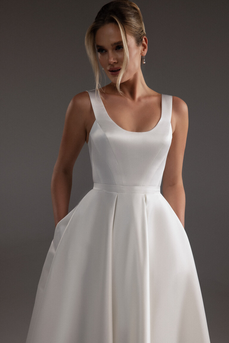 Three-quarter view of the Unona Barbara midi dress bodice in ivory satin, showing the wide scoop neckline and thick straps.