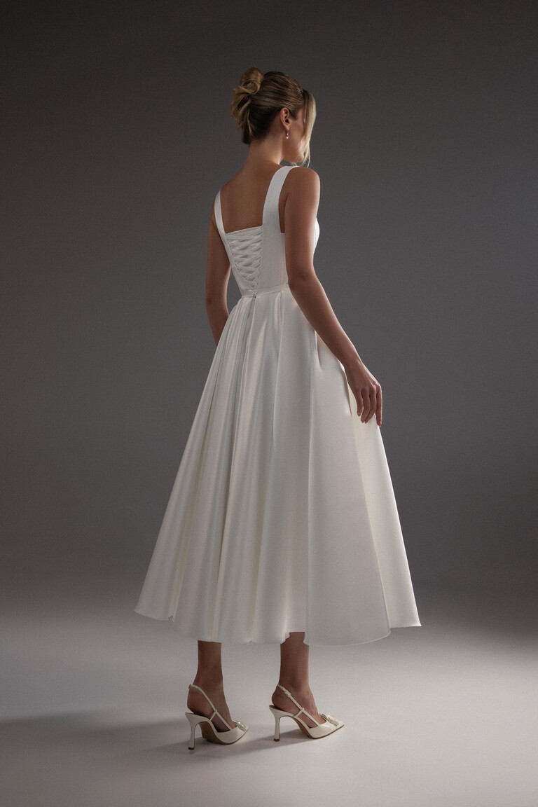 Full back view of the Barbara midi ivory satin gown, featuring the romantic corset-style lace-up closure and A-line skirt.
