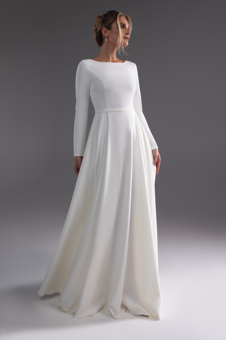 Angled view of Adria stretch crepe wedding dress with defined waistband