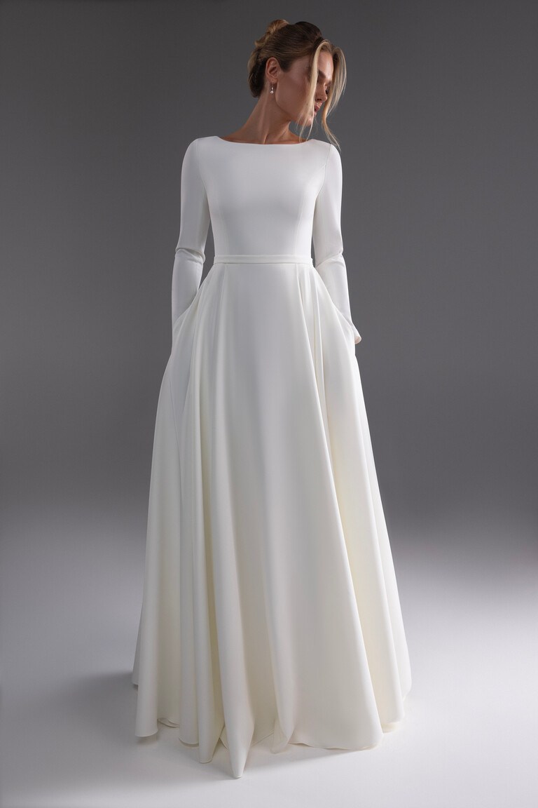 Adria wedding dress front view highlighting A-line silhouette and pockets