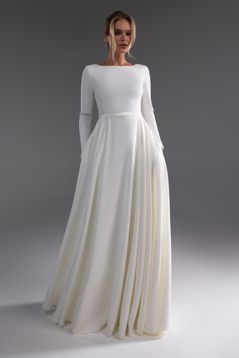 Adria bridal gown front view showing pleated skirt and hidden side pockets