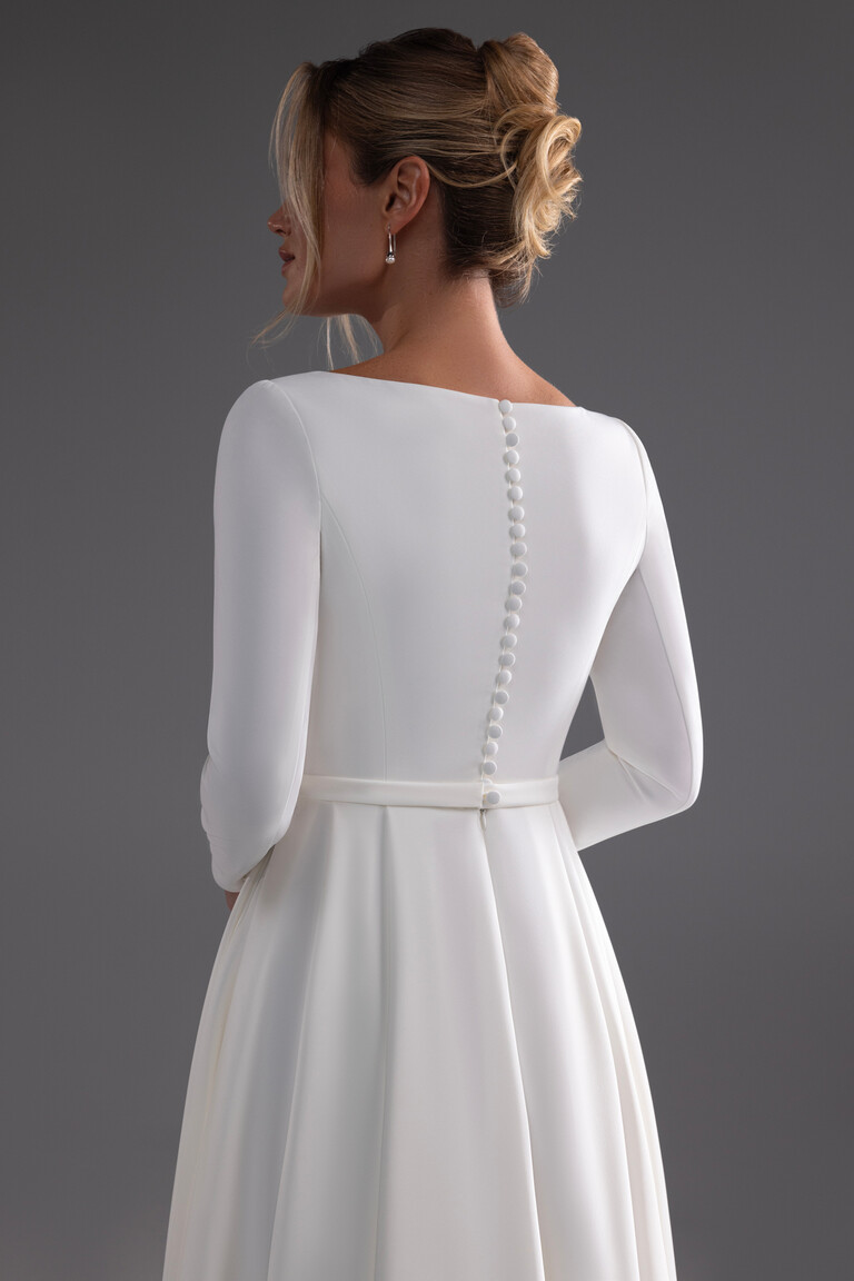 Adria gown rear view showing long sleeves and button details on high back