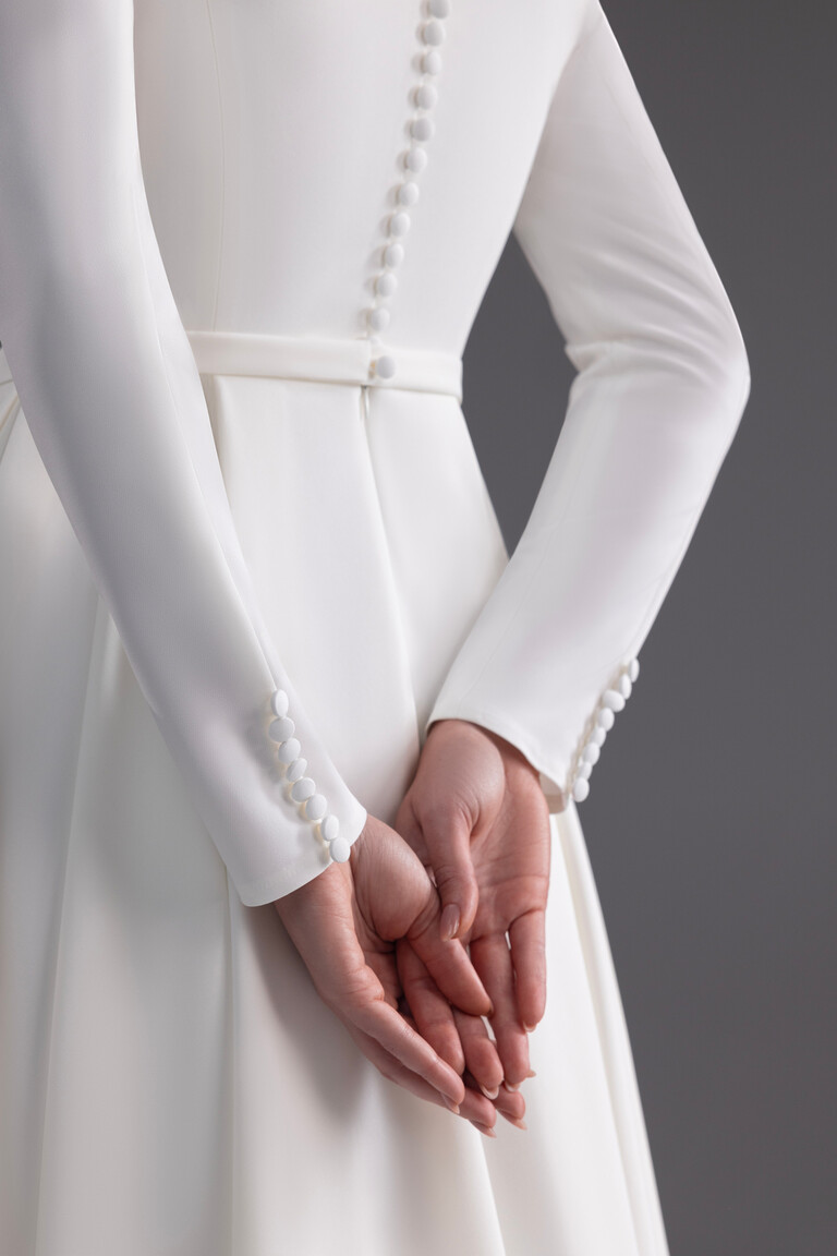 Close-up of Adria dress back showing buttons on spine and sleeve cuffs