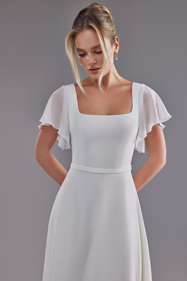 Close up of Edda dress bodice showing square neckline and sheer chiffon flutter sleeves