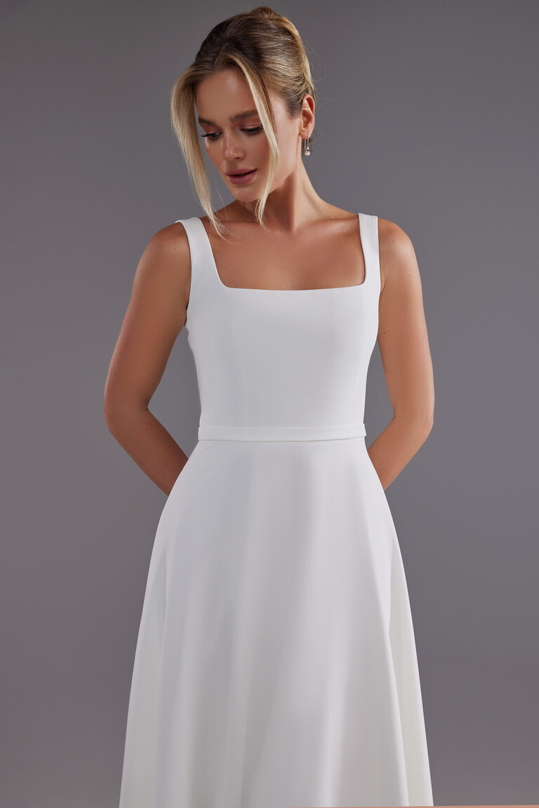 Medium shot of Unona Evita dress showing tailored bodice seams and square neckline