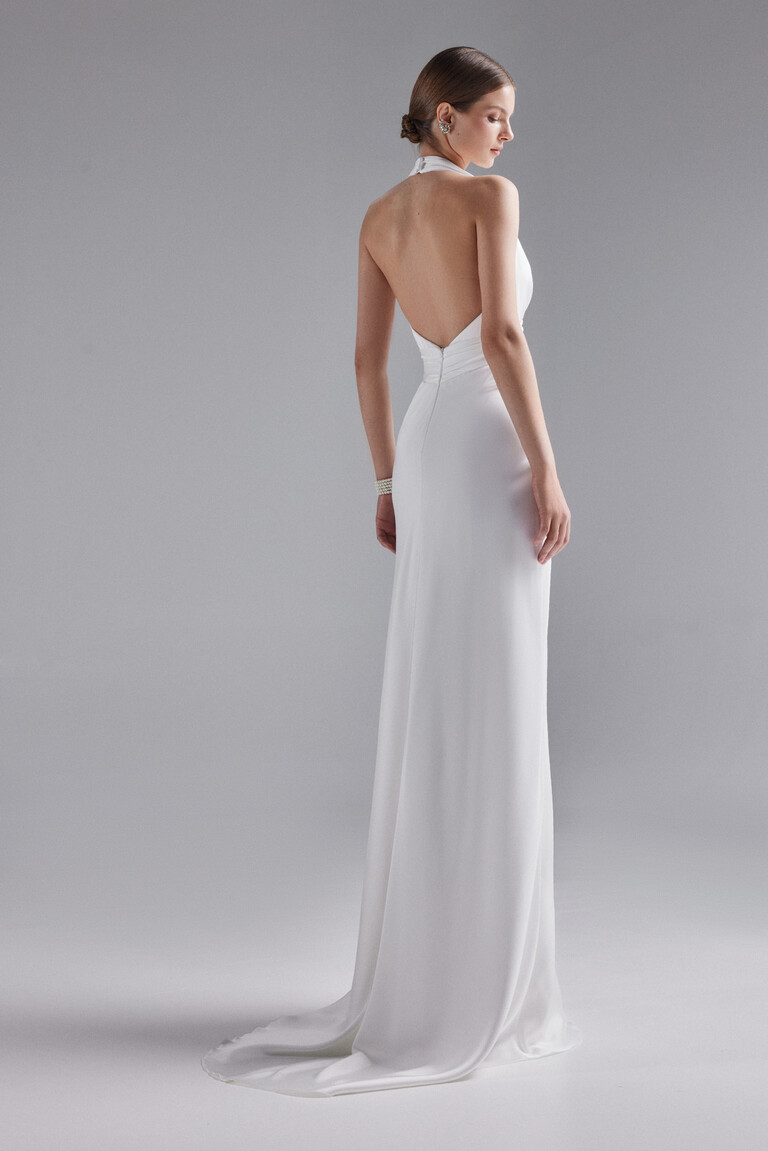 Back view of Athena off-white silk wedding dress showing open back design and floor length skirt