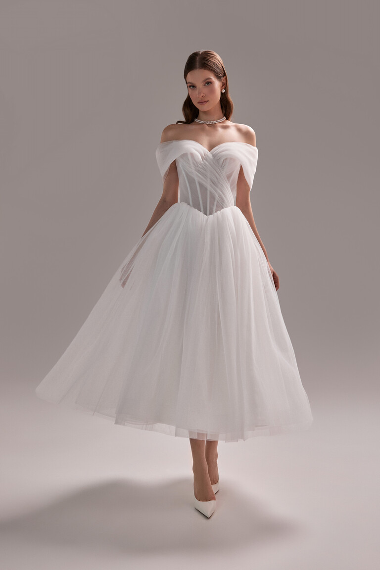 Unona Tutu Midi dress in ivory shown from the front. Romantic tulle gown with off-the-shoulder sleeves and a boned corset.