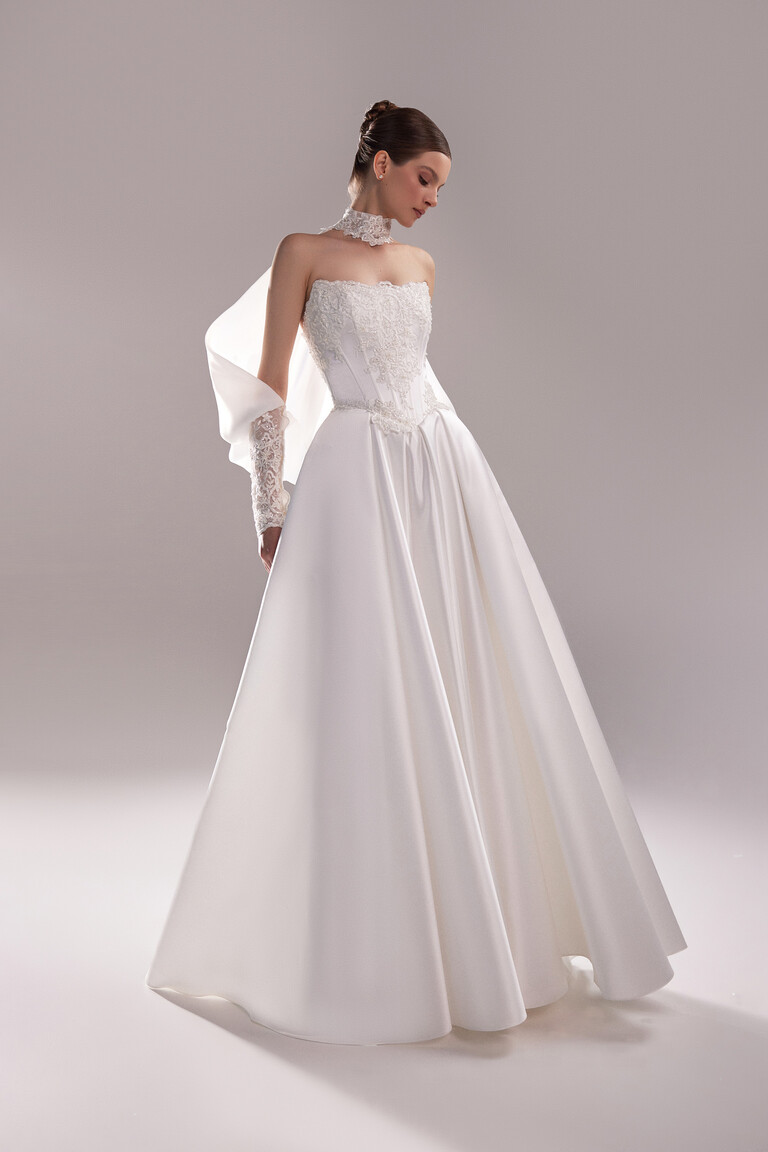 Ethereal Flowing Sleeve Design Angled view of Unona Bolero Demna featuring flowing ethereal organza sleeves and lace neck