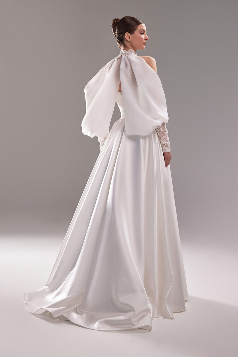 Dramatic Back Detail with Satin Drape Back view of Demna wedding dress featuring dramatic satin drape and lace high neck bolero