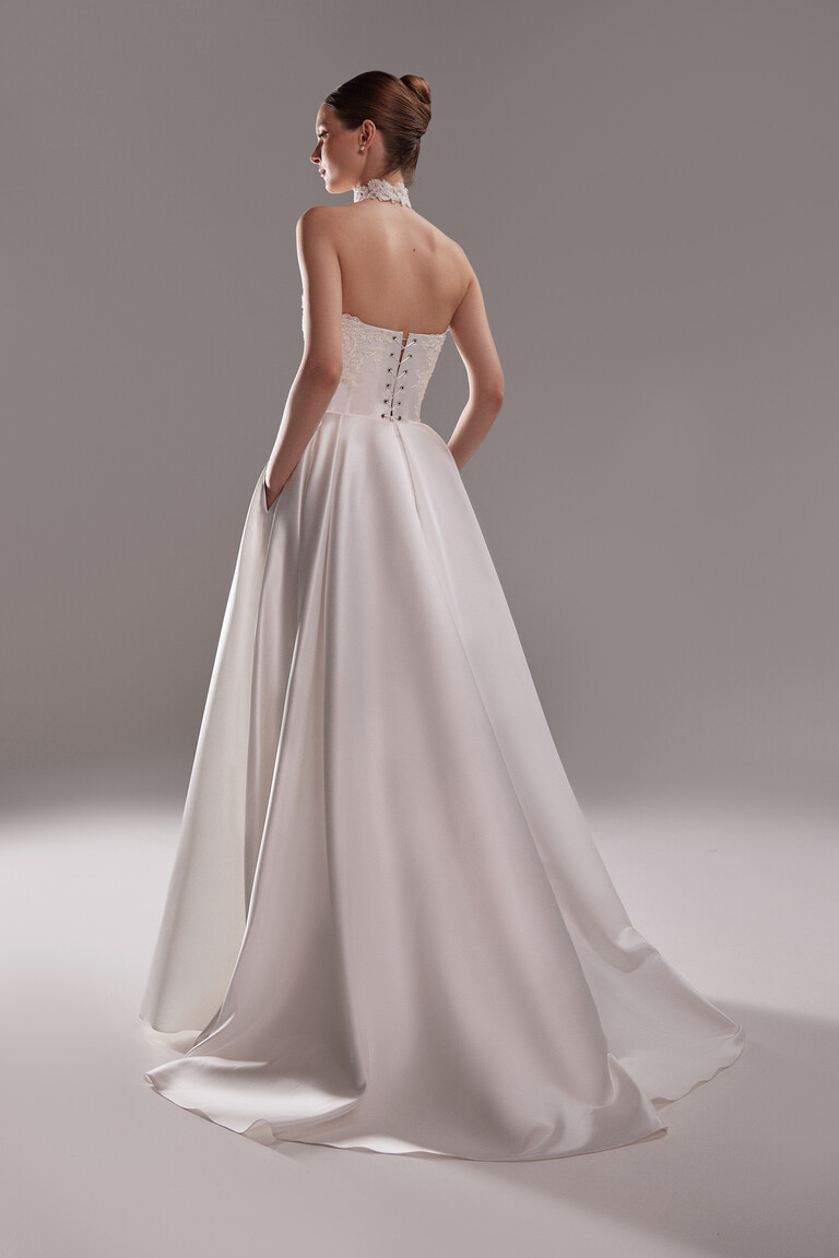 Back view of Demna satin wedding dress with functional pockets and lace up
