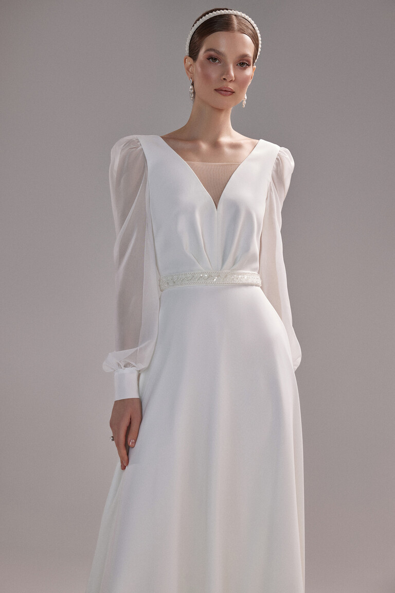 Full front view of the Unona Rita ivory crepe wedding dress showcasing the A-line silhouette and voluminous chiffon sleeves.