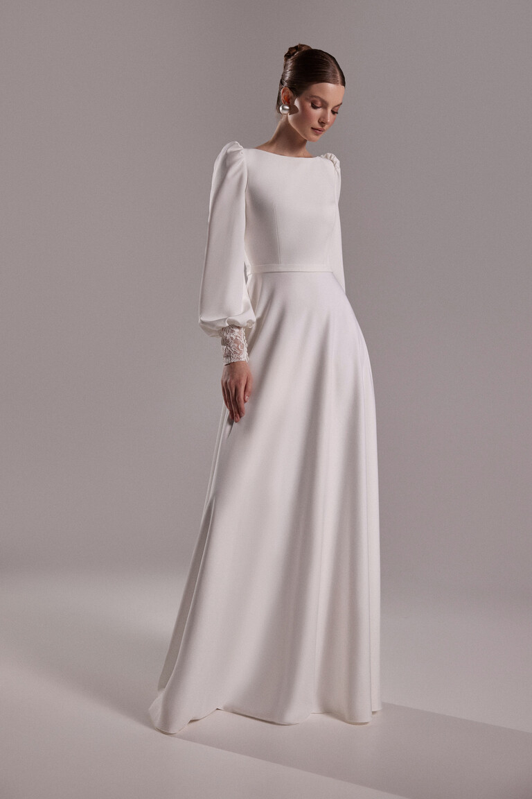Camalia crepe bridal gown side view showing A-line silhouette and long sleeves with delicate lace details