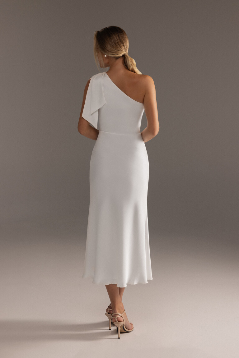 Back view of Julia ivory satin midi dress featuring draped bow detail on shoulder strap