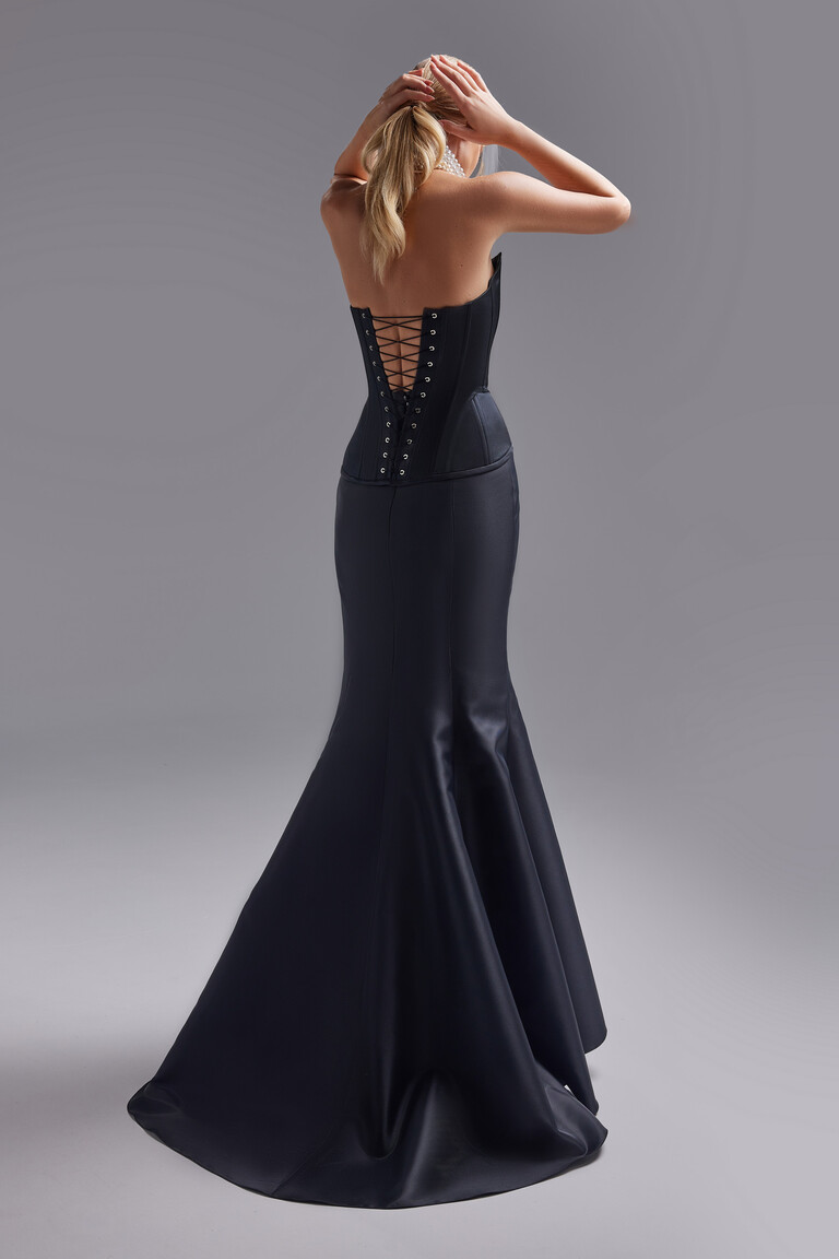 Full back view of the Pina black evening gown featuring the stunning open back with criss-cross lacing on the corset bodice.