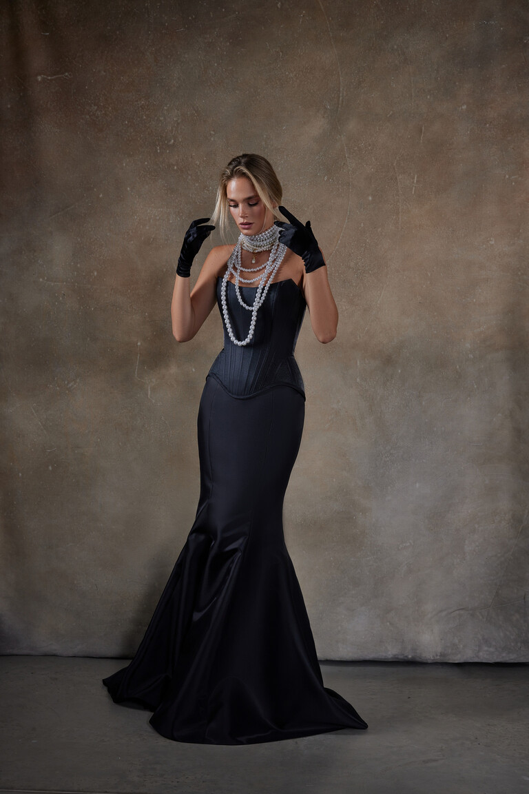 Full length front view of the Unona Pina black mermaid gown featuring a structured strapless corset and elegant mikado fabric.