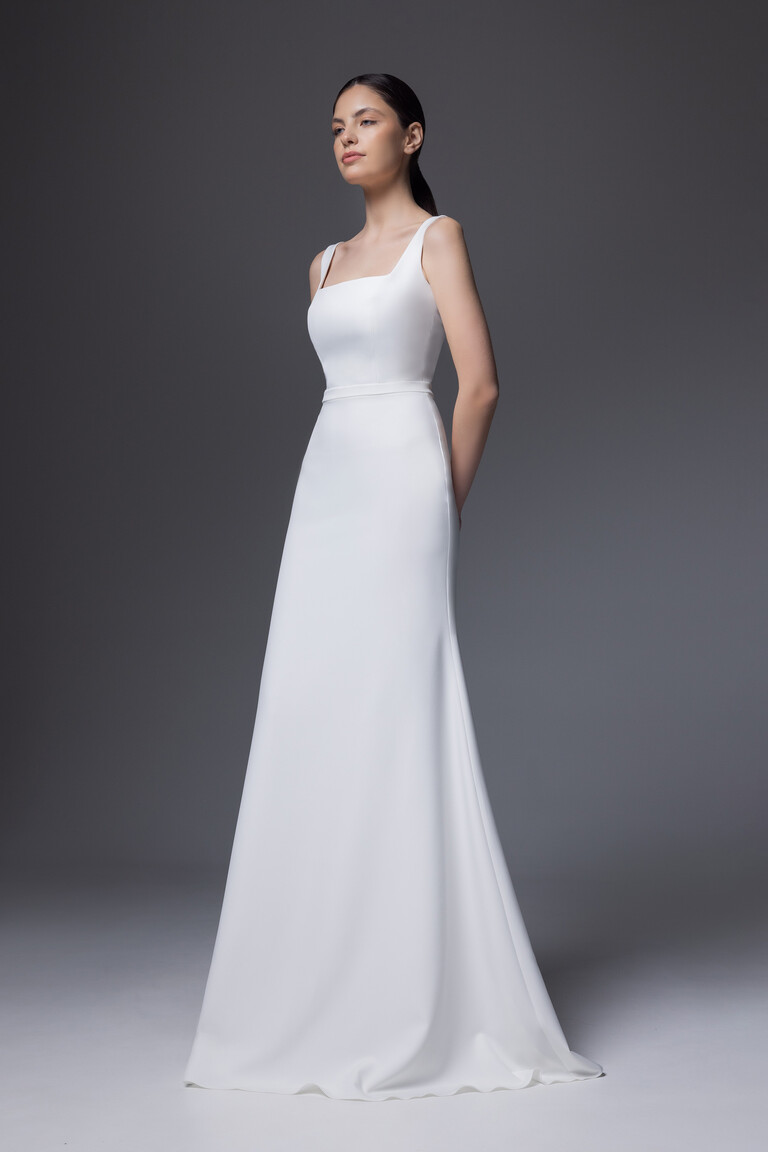 Front side angle of Bethany ivory crepe gown showing smooth skirt drape and fitted bodice