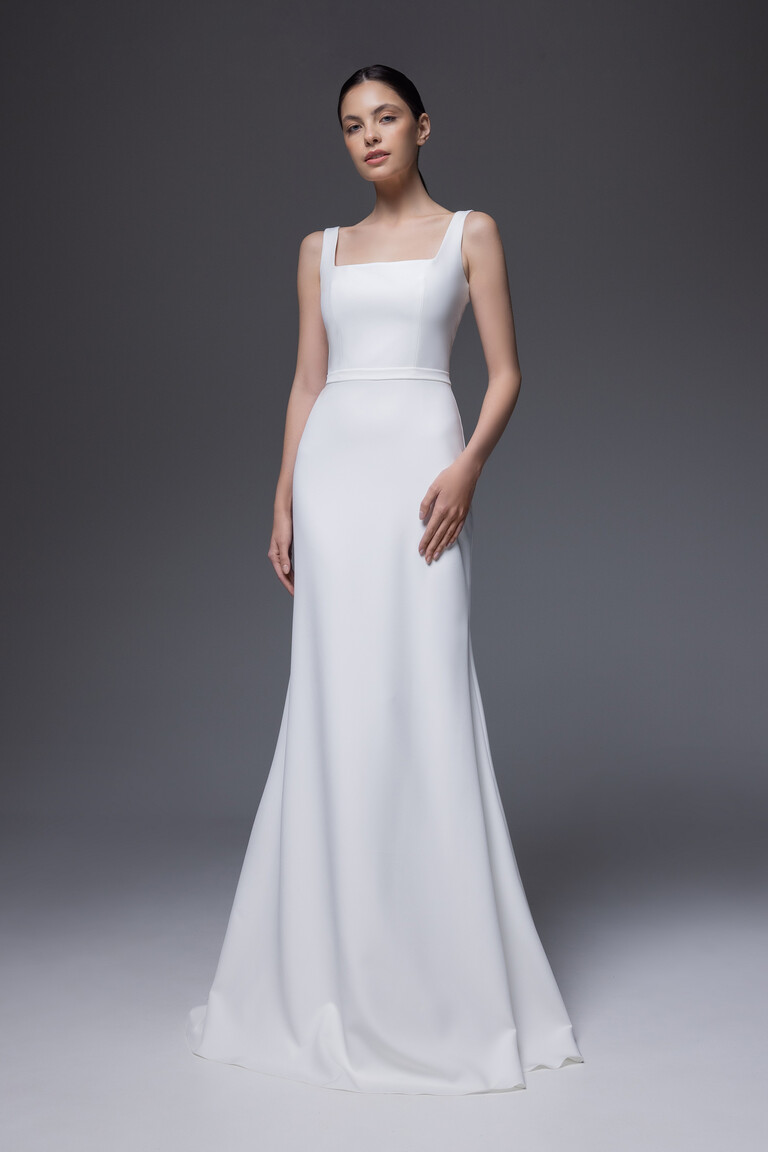 Full length Bethany wedding dress in ivory crepe displaying modern minimalist sheath cut