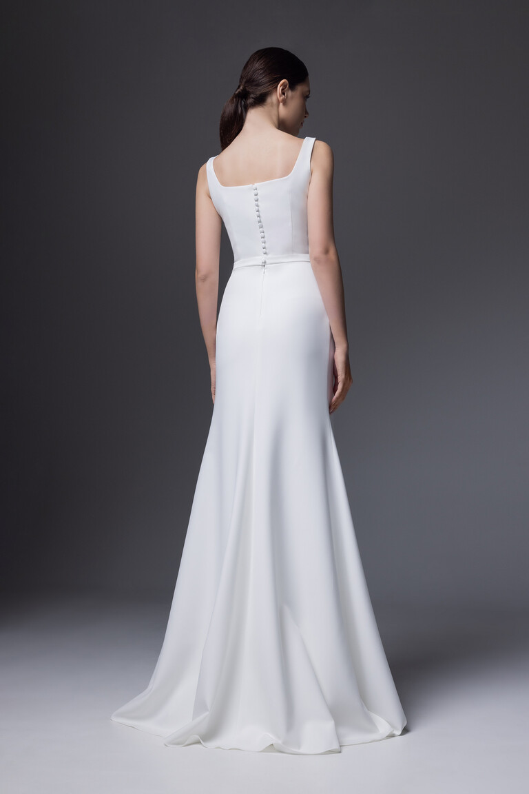 Full length back view of Bethany gown featuring row of covered buttons and smooth crepe skirt