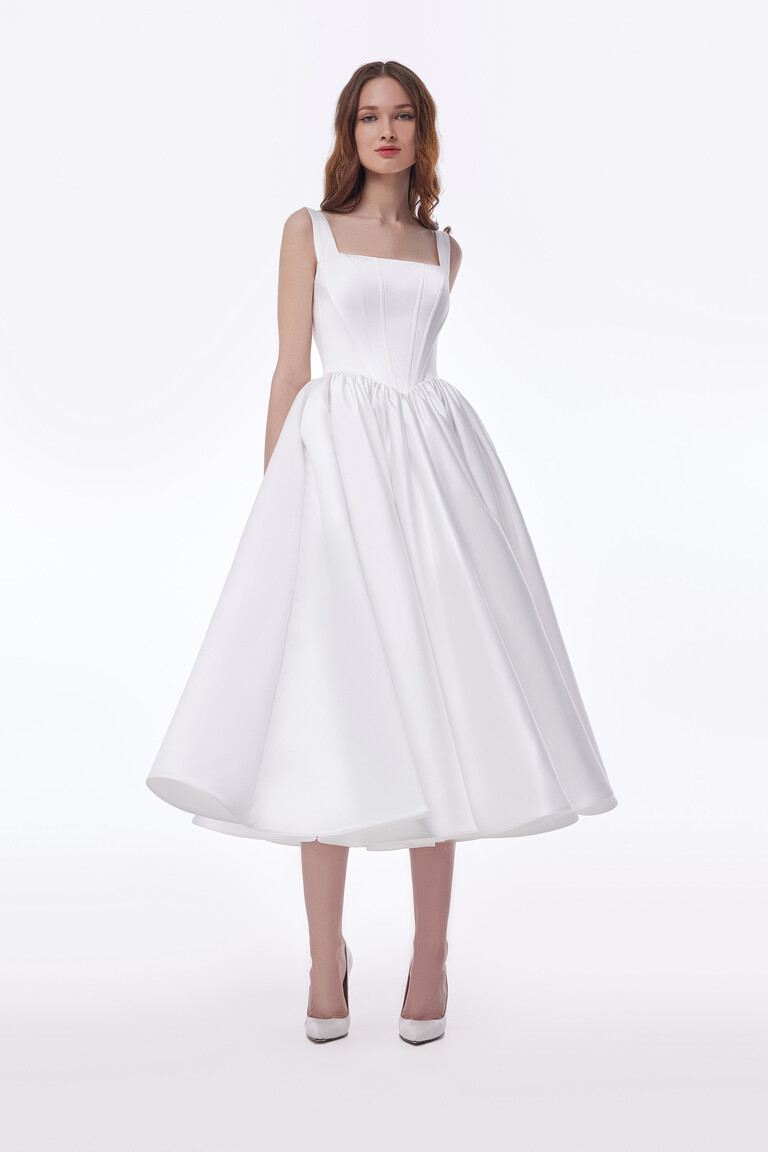 Full length view of Casia ivory satin tea length wedding dress with structured corset bodice