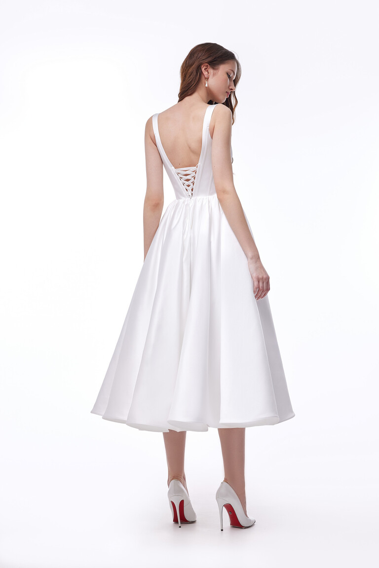 Back view of Casia Midi dress showing lace up closure and ivory satin A line skirt
