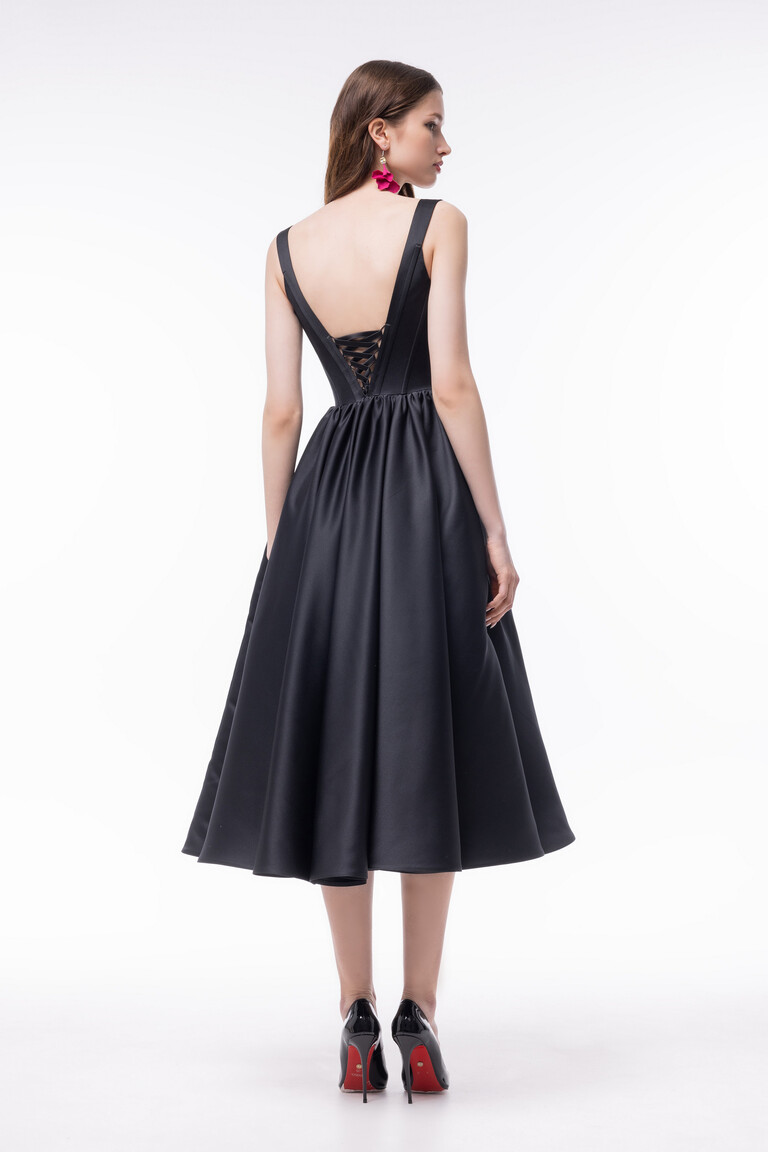 Casia Dress Rear View with Lace-Up Back and A-Line Skirt Back view of Casia black satin dress featuring V-shaped open back with lace-up detailing and full skirt