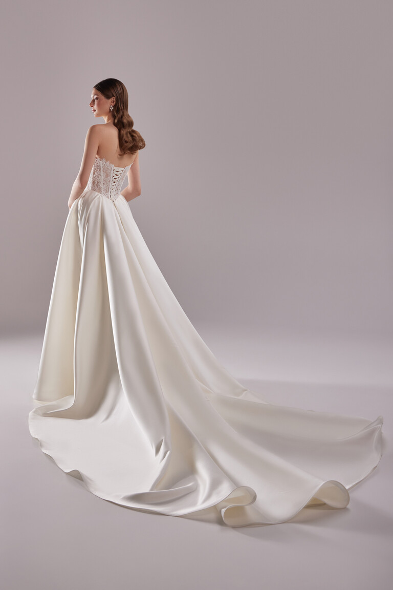 Back view of Evelyn A-line wedding dress showing lace-up corset and long satin cathedral train