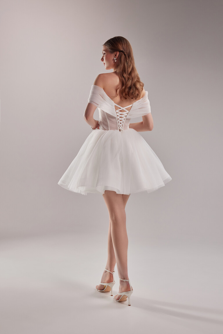 Full rear view of the Tutu mini short ivory wedding dress showcasing the lace-up back and playful A-line pleated tulle skirt.