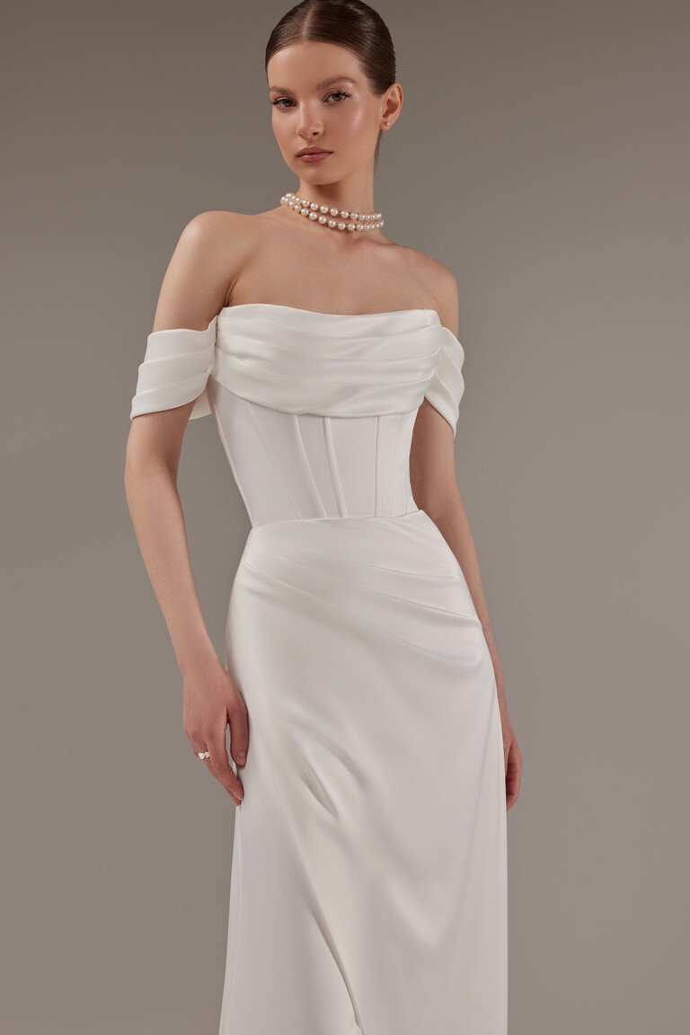 Unona Riley off-shoulder satin gown featuring draped neckline and fitted sheath silhouette in ivory