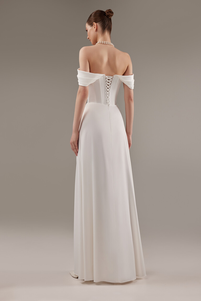 Full length back view of Riley ivory satin wedding dress with lace-up closure and flowing column skirt