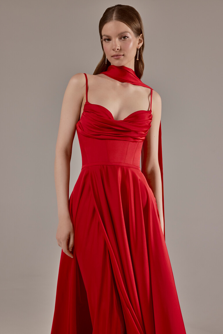 Full front view of the Unona Ingrid red formal gown highlighting the structured corset and flowing silk skirt