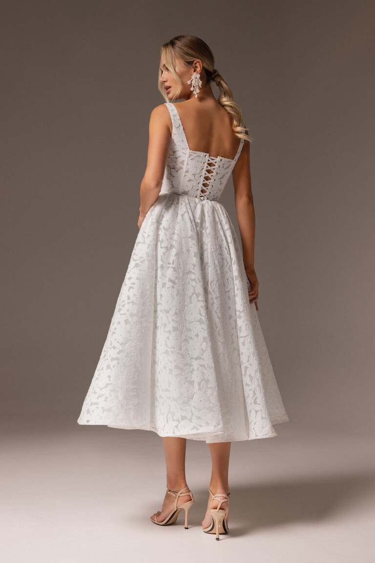 Elegant Lace-Up Back Detail on Ruta Midi Wedding Gown Back view of Ruta tea-length bridal gown showing lace-up corset and floral lace texture