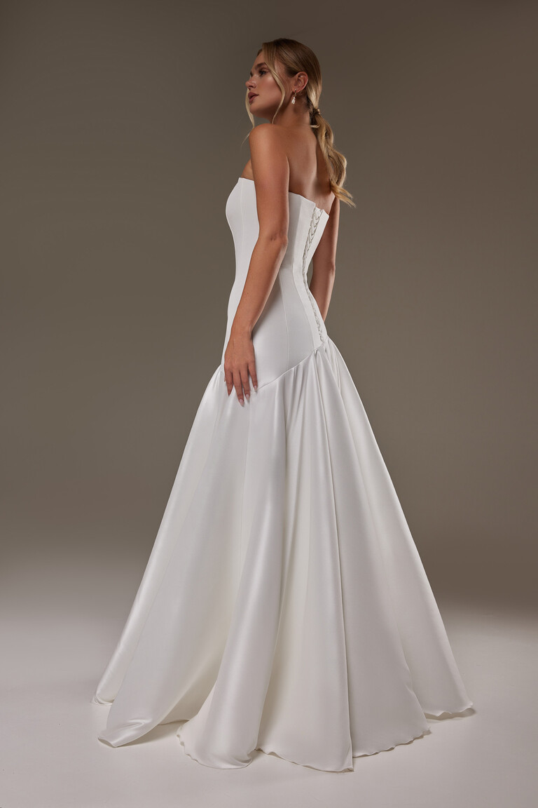 Back view of Holly ivory bridal gown featuring corset lacing and fit-and-flare silhouette