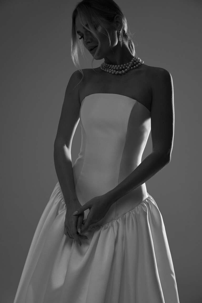 Black and white medium shot of Francesca drop waist gown bodice styled with pearl choker necklace