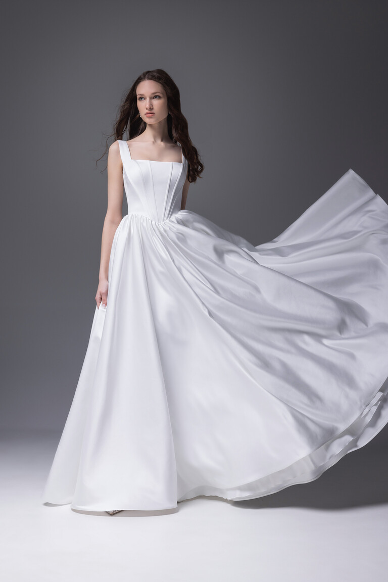 Casia wedding dress with voluminous satin skirt showing movement and corset fit