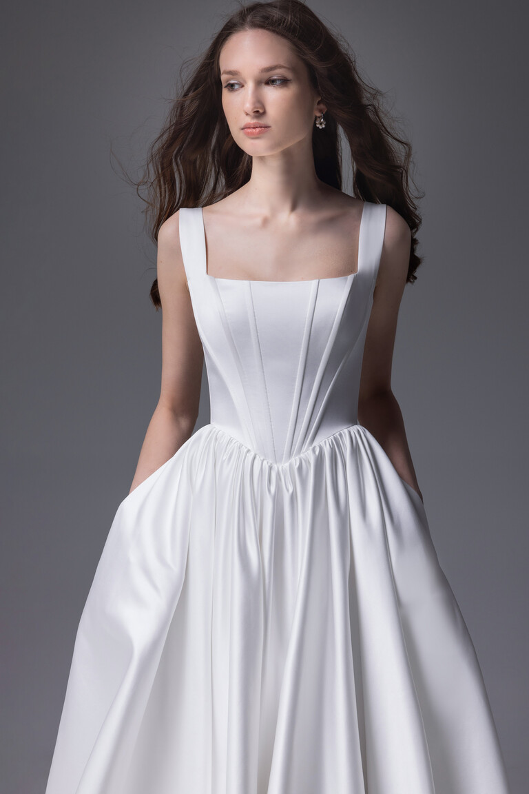 Casia ivory satin bridal dress featuring side pockets and structured corset bodice