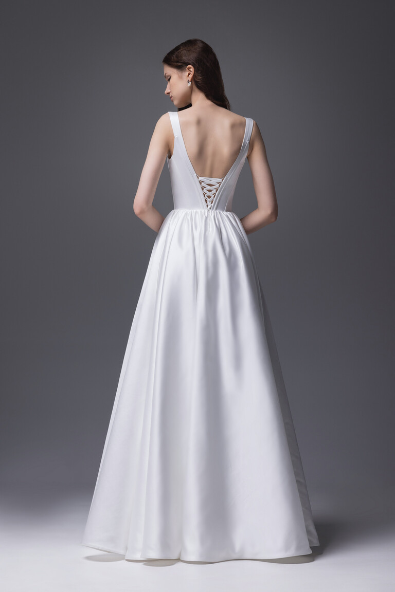 Rear view of Unona Casia dress showing satin A-line skirt and corset lacing