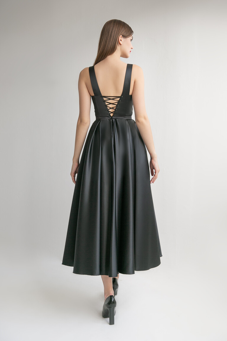 Back view of the Unona Barbara midi black dress highlighting the elegant corset lace-up closure and A-line skirt.
