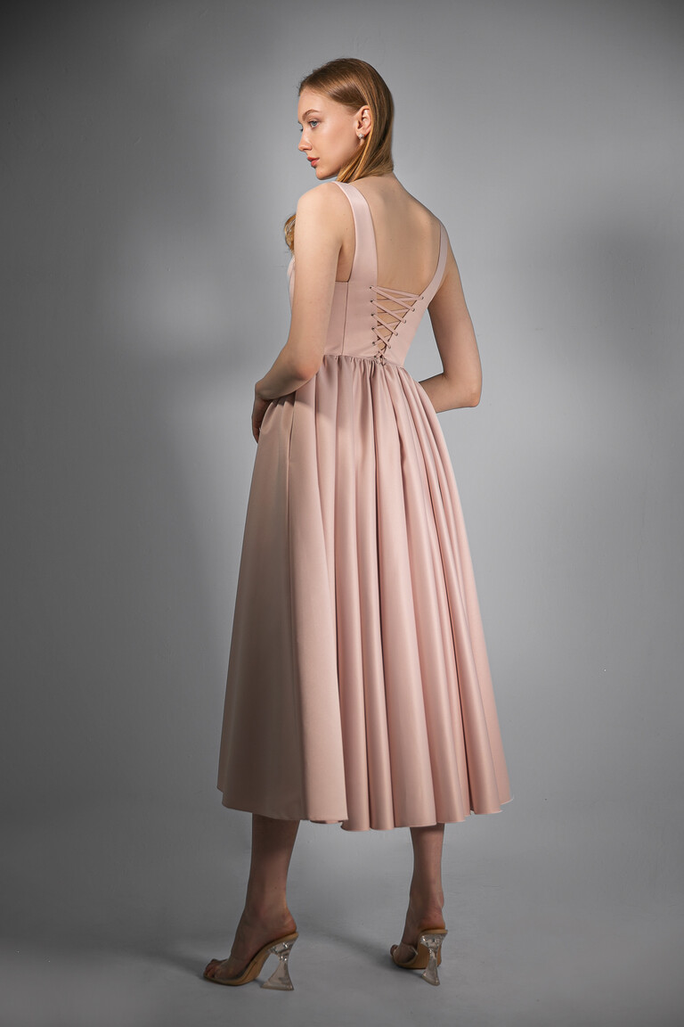Back view of the Unona Barbara midi powder pink dress highlighting the adjustable corset lace-up closure