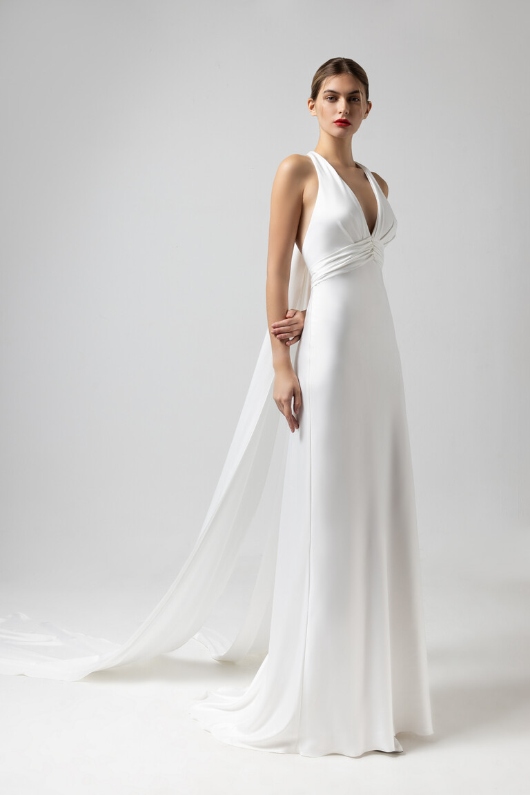 Athena off-white wedding gown 3/4 view with long fabric panels trailing like a watteau train